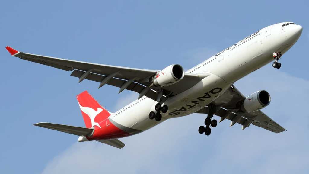 A photograph of a Qantas plane in flight.