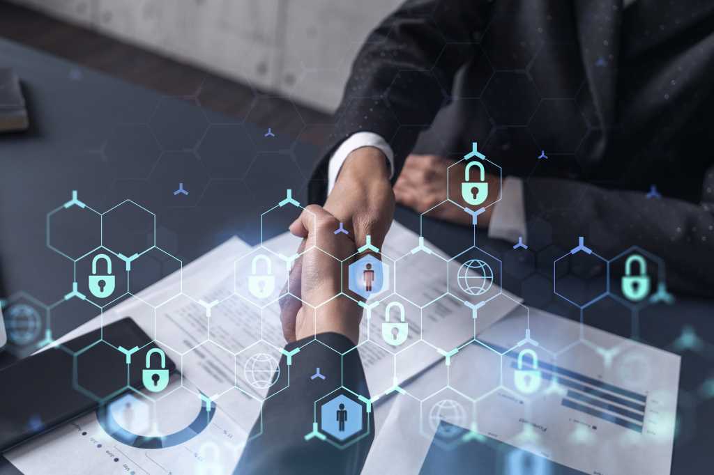 Handshake of two businesswomen who enters into the contract to protect cyber security of